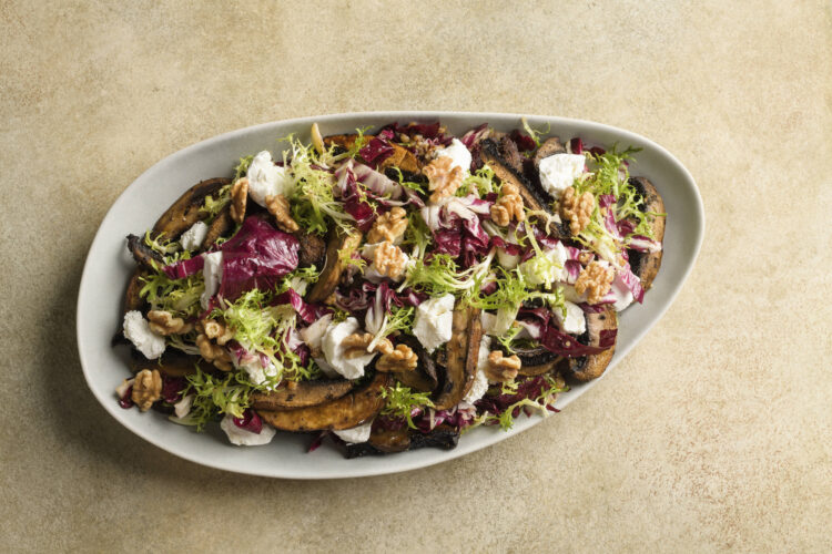 Tangy goat cheese balances meaty  mushrooms in a simple vegetarian salad